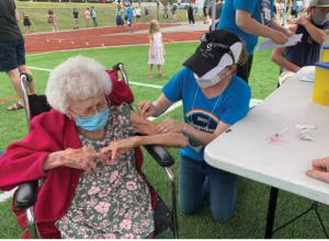 One of more than 800 patients receives her COVID vaccine at a recent Immaculata High School Jabapalooza community vaccination event . Photo Supplied