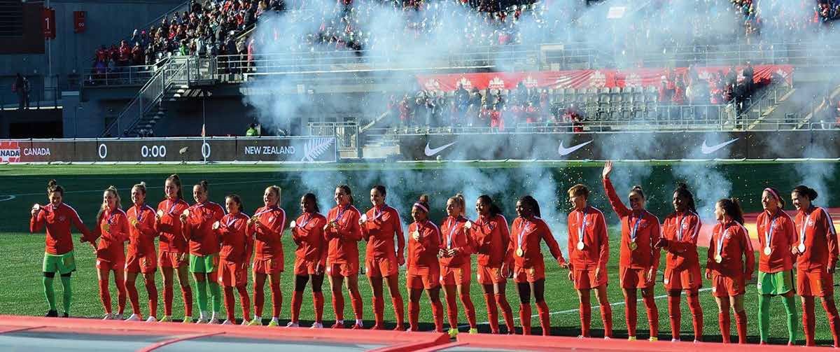 Canada's gold medal-winning women's soccer team salute the fans at TD Place Stadium prior to kick-off. Photo by Peter Fowler