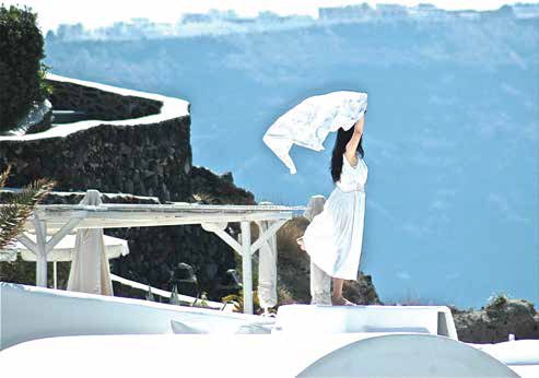 “I spotted this bride in Santorini, Greece, where weddings have multiple film crews. I was staying just below where the bride was staying. She had escaped to get away from the hubbub—a rare moment of freedom—allowing the breeze to blow her veil.” Photo by Peter Fowler