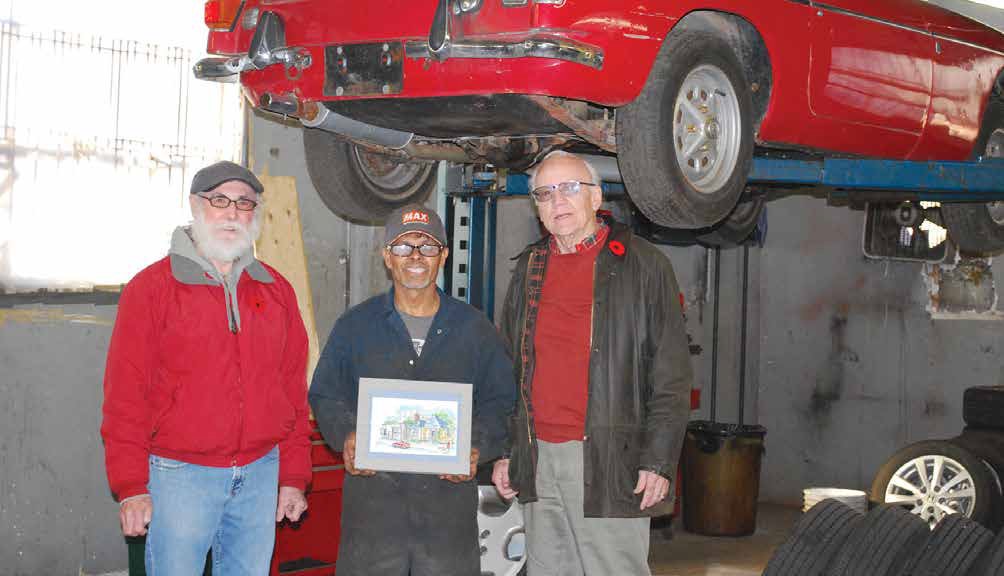 Craig Turner and Brian Harrison, two self-described "old British car fans", presented Tim Hunt's sketch of Redshaw Auto Care to owner Prem Sookdeo. Photo by Michael Turner