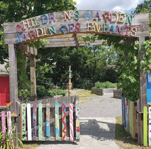 Colourful signage and picket fence make for a bright welcome to the Chrilden's Garden. Photo by Lorne Abugov