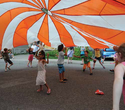 Singing, dancing and a giant parachute canopy were among the highlights of the 25th anniversary street celebration that captured the spirit of Terra Firma and its founding families. Photo by Paul Scott 