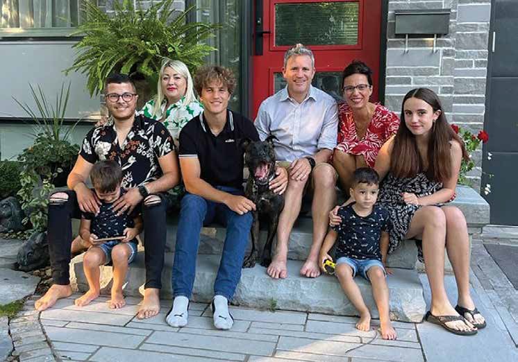 Left to right: El Mahdi Aouaj (with son Raian Aouaj), Mariia Aouaj, Jay Yetman, Michael Yetman, Alex Peach with Amir Aouaj in front of her and Carolyn Yetman - and the Yetman family dog, Tui, in the middle. Photo Supplied