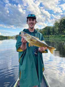 Porter MacLennan at ease on the Rideau River with a catch and release walleye. Photo Supplied