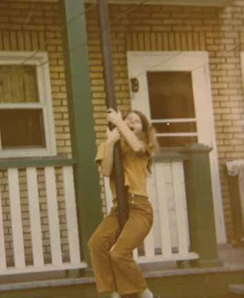 A neighbour girl sliding down from the balcony of 121 Glenora, apartment 3, circa 1968. Notice our clothesline mounted on the left frame of our kitchen door. Photo Supply Rockburn Family