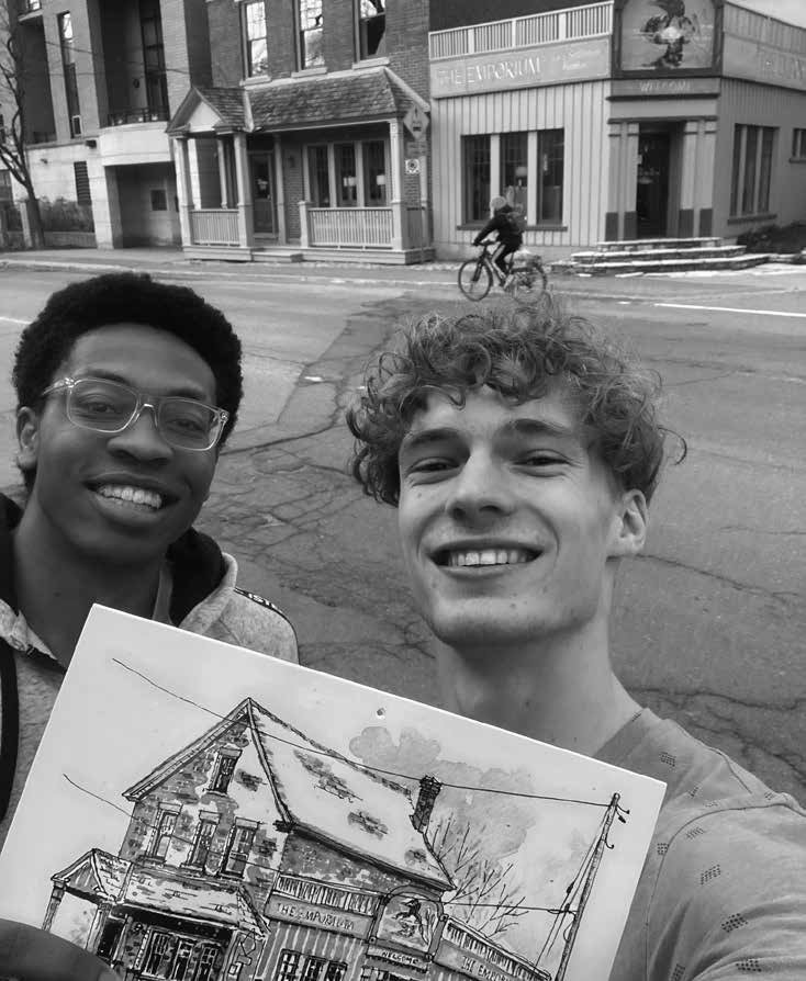 Zane Shepherd (right) and one of this housemates, Muiz Mustafa, pose in front of The Emporium furniture store with Tim Hunt’s urban sketch. Housemate Samuel Tam, not pictured, is working in Montreal this summer. The young engineering students have been curious about the store and whether or not they might find something for their household inside. Photo by Zane Shepherd