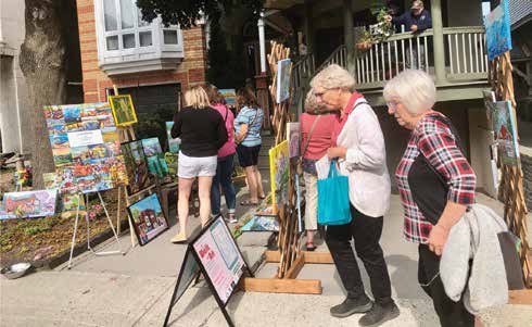 Louise Rachlis exhibits on Graham Avenue - a very successful day with lots of strollers and cyclists viewing the artist's vibrant work. Photo by Josh Rachlis 